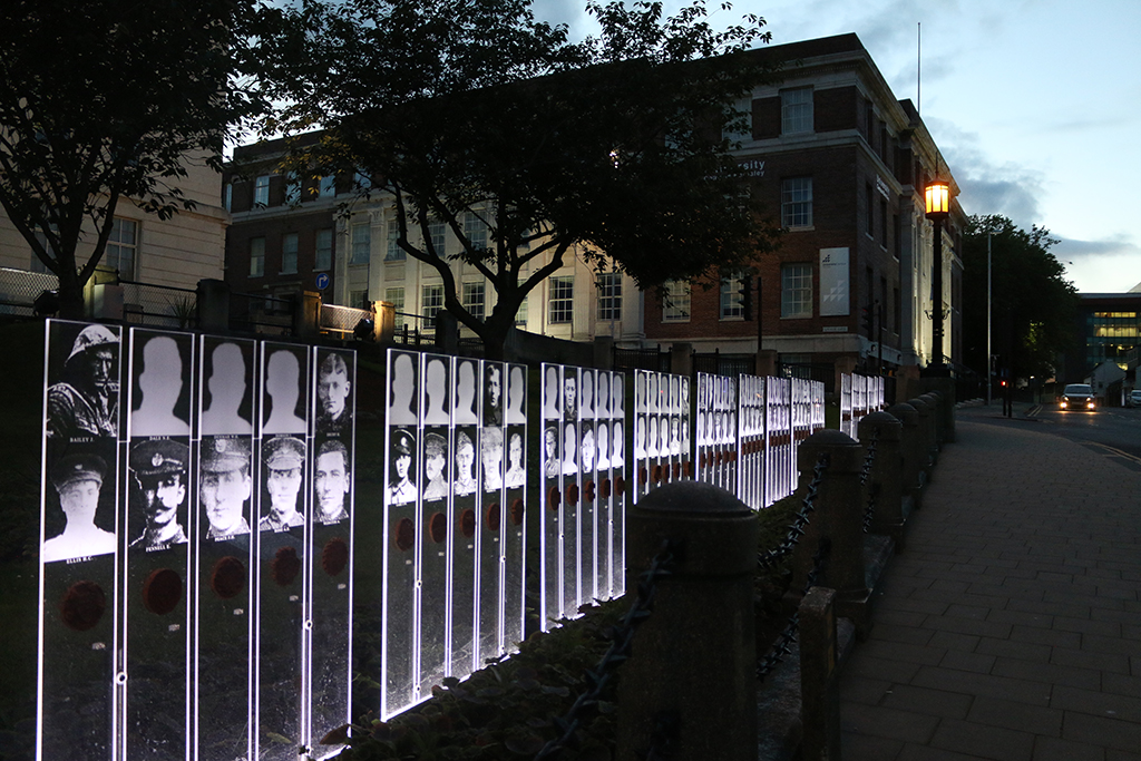 Lit up clear acrylic engraved with images of fallen soldier from WWI